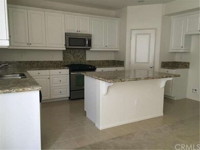 Kitchen with white cabinets, stainless steel appli