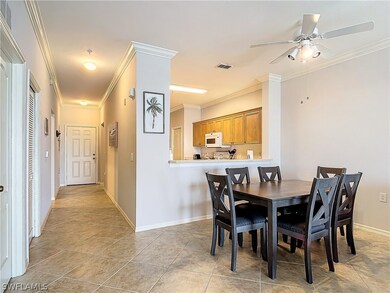 Tiled dining room with crown molding and ceiling f