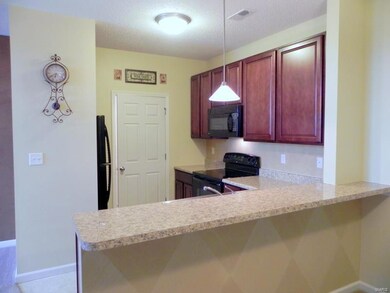 Kitchen and breakfast bar as seen from dining area