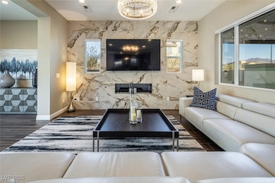 Large great room with gas fireplace and custom til