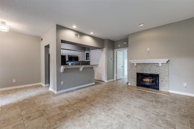View of wood burning fireplace in living room