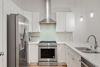 Kitchen featuring stainless steel appliances, wal