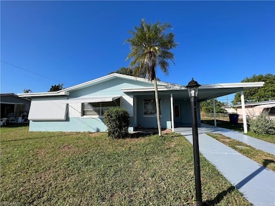 View of front of home with a carport and a front l