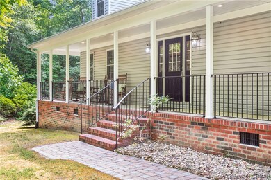View of exterior entry featuring covered porch