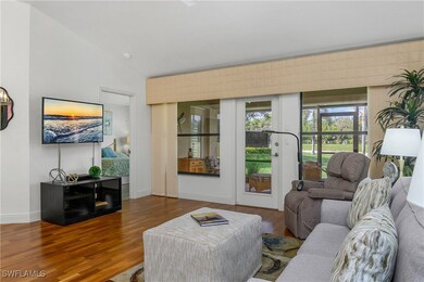 Living area featuring wood finished floors, vaulte