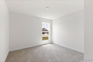 Carpeted empty room featuring baseboards
