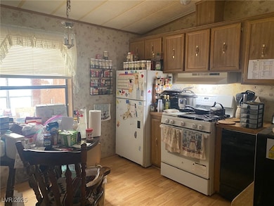 Kitchen featuring white appliances, under cabinet