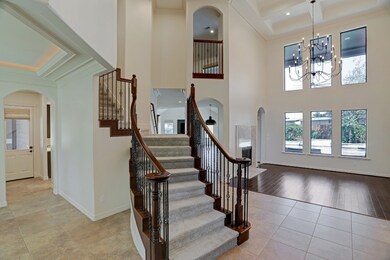 Double entry stairway off the foyer with gorgeous wrought iron staircase.