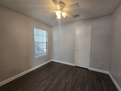 Empty room featuring dark wood finished floors, a