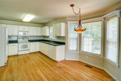 Kitchen has HW floors and eat in area by bay windo
