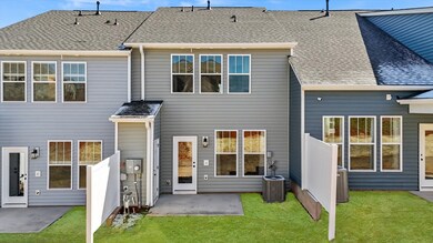 Townhome exterior with craftsman design, large windows, garage, two car parking pad, and blue siding at Aspen Ridge in Lyman