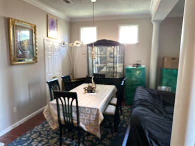 Dining area with decorative columns, crown molding