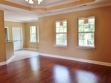 Large living area has wood flooring, step ceiling