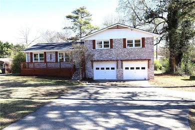 Split level home featuring aphalt driveway, stairw