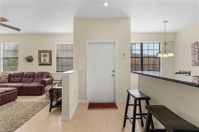 Tiled foyer entrance with ceiling fan with notable