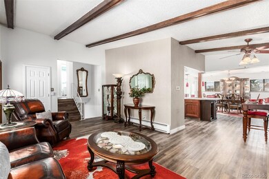 Open floor plan with exposed wood beams