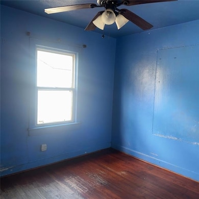 Bedroom 2 with dark wood-type flooring and ceiling