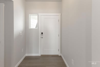 Foyer featuring baseboards and wood finished floors