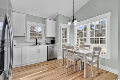 Kitchen featuring white cabinetry, stainless steel