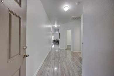 Hall featuring light wood-style flooring and base