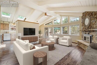 Living room with beamed ceiling, hardwood flooring