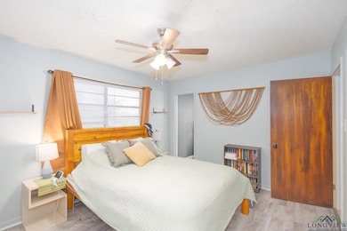 Bedroom featuring wood finished floors and ceiling fan