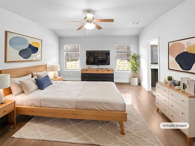 Bedroom featuring wood finished floors, baseboard