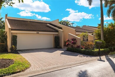View of front of home with decorative driveway, a