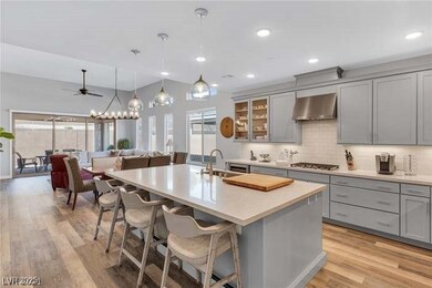 Kitchen with gray cabinets, a sink, stainless stee