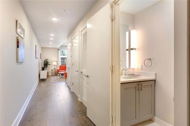 Entrance hallway with half bathroom then washer/dr