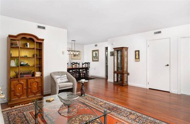 Living area featuring baseboards, visible vents, a