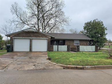 Ranch-style house featuring an attached garage, fe