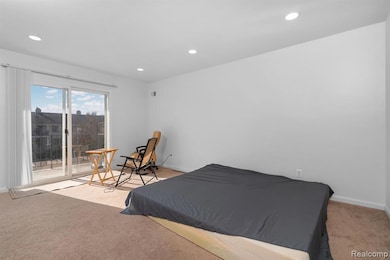 Bedroom with light carpet, recessed lighting, and access to outside