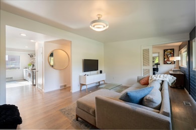 Living room with light wood finished floors and baseboards