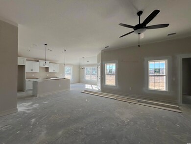 Unfurnished living room featuring ceiling fan and 