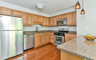 Kitchen has been updated with maple cabinetry, gra