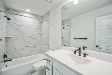 Full bath featuring vanity, shower / washtub comb