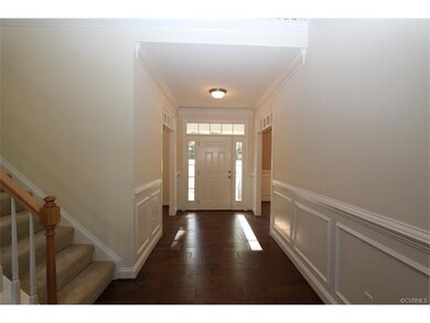 Foyer with transoms over the front door, entry to 