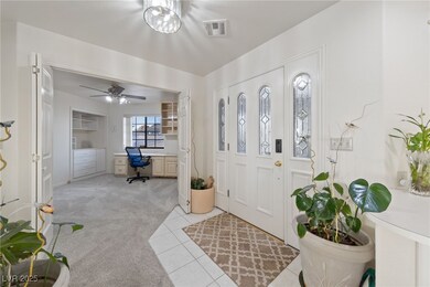 Foyer featuring light carpet, light tile patterned
