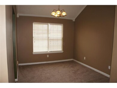 Lovely dining room is embellished with a chandelie