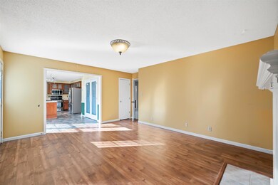 Living Room Is Open to the Kitchen! Beautiful Glass Double Pantry Doors! 