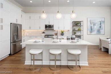 Kitchen with stainless steel appliances, light cou