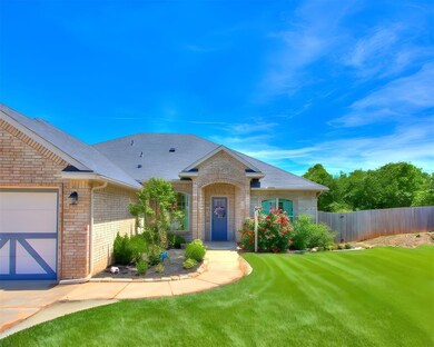 Single story home with brick siding, fence, an att