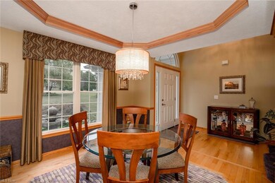 Adjacent to the foyer is the formal dining room with a trayed ceiling and hardwood bordered floor.