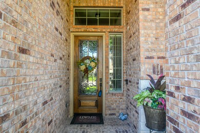 This cozy covered, brick lined front entrance is n
