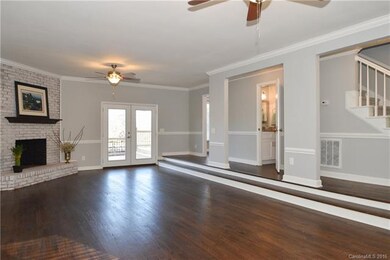 Large living room with new wood floors, light fixt