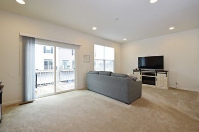 With sliding glass doors leading to expanded deck