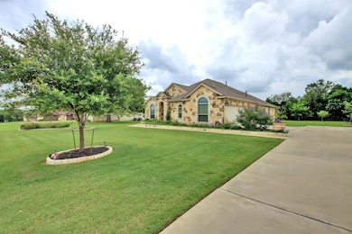 View of front facade featuring stone siding and a