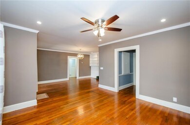 Empty room with crown molding, light wood-type flooring, a ceiling fan, a chandelier, and recessed lighting