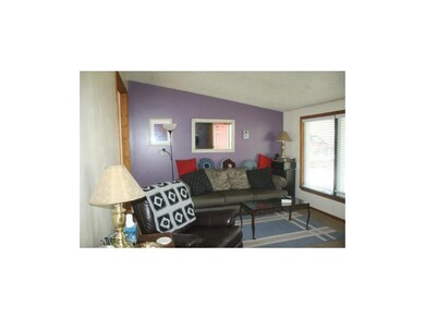 large living room with picture windows looking out